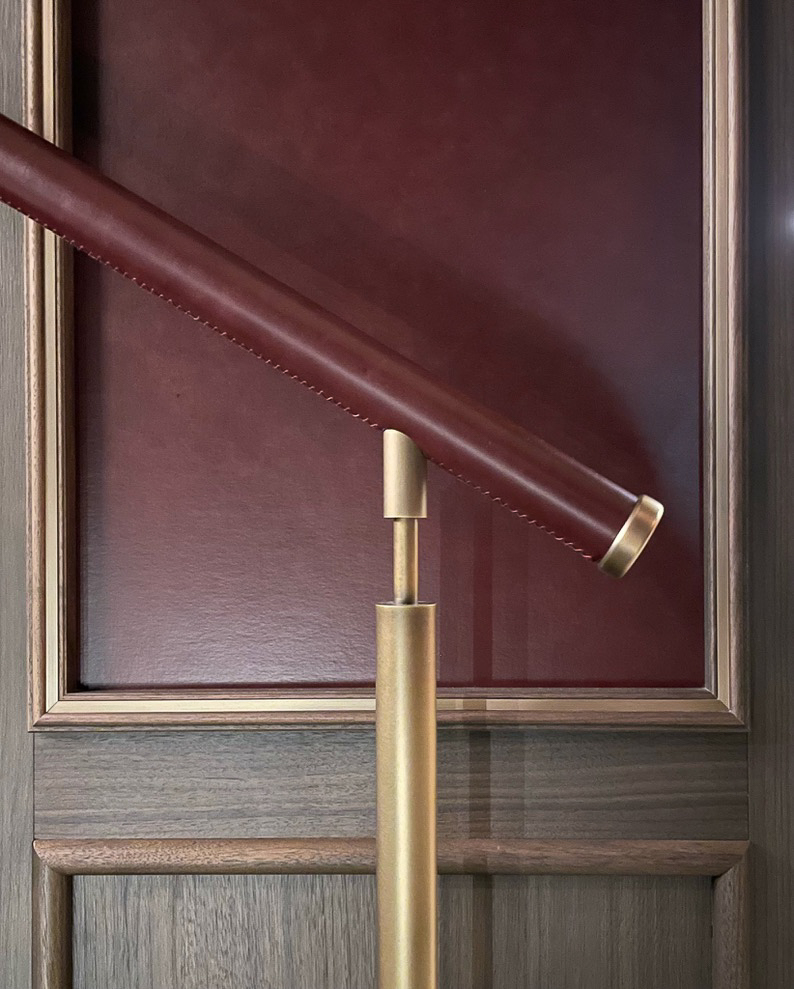 Leather-covered handrail on brass support